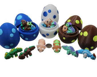 May include: A set of colorful plastic dinosaur eggs with a variety of small dinosaur figurines inside. The eggs are decorated with blue, white, brown, and yellow polka dots.