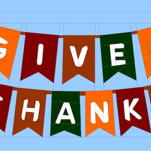 Puede incluir: Una pancarta festiva con las palabras "GIVE THANKS" en letras blancas sobre banderines coloridos. Los banderines son en tonos de naranja, marrón y verde, sobre un fondo azul claro. Un gráfico de hoja está en un banderín.
