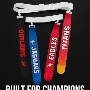 Puede incluir: Imagen de cinturones de bandera con los textos "OUTLAWS", "JAGUARS", "EAGLES" y "TITANS". Los cinturones son negros, azules, rojos y naranjas. También se ve el texto "FAIRHAVEN INDUSTRY" y "BUILT FOR CHAMPIONS".