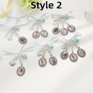 May include: Six memorial photo charms featuring silver-toned oval frames, white pearl beads, teal accent beads, and heart-shaped charms engraved with the text You are always in my heart. Each charm is tied with a white satin ribbon bow.