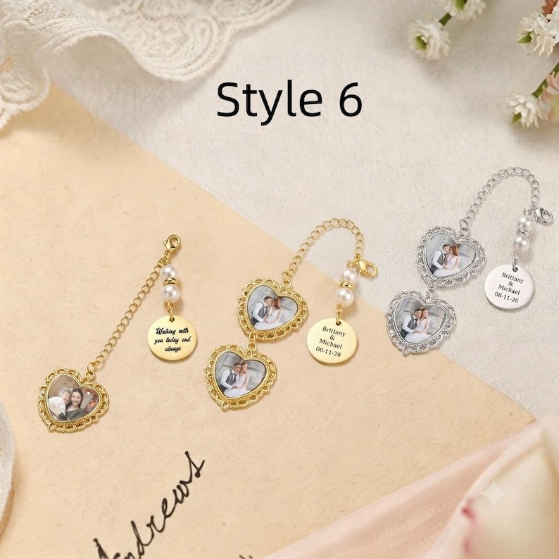May include: Three heart-shaped photo charms with gold and silver metal frames. Each charm features a chain, two small white pearls, and a round metal tag engraved with text. The charms display miniature wedding photos inside the heart frames.