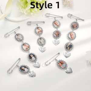 May include: Six silver-toned safety pin brooches featuring oval photo frames and heart-shaped charms engraved with the text "You are always in my heart." The brooches display various portrait photographs of individuals within the ornate metal frames.