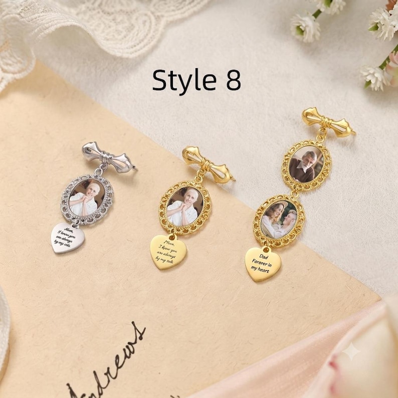 May include: Three metal photo charms labeled Style 8. Two are single oval frames with heart pendants, one silver and one gold. The third is a gold double oval frame with a heart pendant. Each frame contains a portrait photo and text.