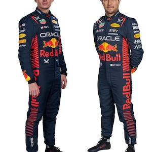 May include: Two race car drivers wearing dark blue racing suits with red and white accents. The suits have the logos of Oracle, Red Bull, and Bybit. The drivers are standing on a white background.
