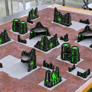 May include: A collection of miniature tabletop wargaming terrain pieces featuring black ruins and structures with bright neon green glowing accents and symbols. The set includes various wall sections, cylindrical towers, and corner ruins.