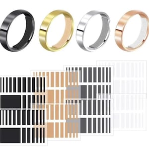 May include: Four rings in different metallic finishes: black, gold, silver, and rose gold. The rings are flat and simple in design. Below the rings are several sheets of stickers with black, tan, and white vertical stripes.