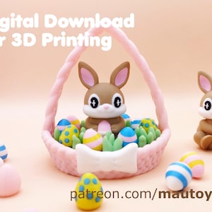 May include: A brown bunny figurine sits in a pink basket filled with colorful Easter eggs and green grass. The basket has a white bow on the front. The image includes the text "Digital Download for 3D Printing" and "patreon.com/mautoylab".