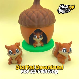 May include: A 3D printed brown acorn-shaped house with a green base and three small brown squirrel figurines with large white eyes. The text Mau ToyLab and Digital Download For 3D Printing are visible on the image.