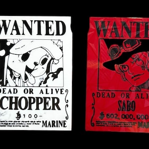 May include: Two "Wanted" posters. One is white with a cartoon dog and the name "Chopper", the other is red with a character wearing a hat and the name "Sabo". Both posters have the text "Dead or Alive" and a bounty amount.