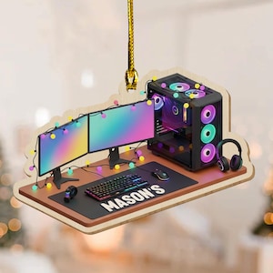 May include: A wooden ornament featuring a gaming setup with two monitors, a computer tower, keyboard, mouse, and headphones. The setup is decorated with colorful lights and the name "MASON'S" is displayed on the desk.