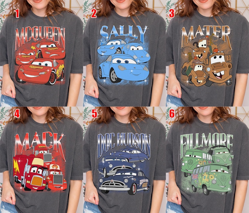 May include: Six gray t-shirts featuring characters from the movie Cars. Each shirt has a different design, including McQueen, Sally, Mater, Mack, Doc Hudson, and Fillmore, in a vintage style.