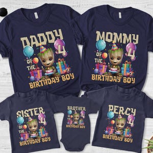 May include: Navy blue family birthday shirts featuring a Groot character holding a cake, balloons, and gifts. The shirts read "Daddy", "Mommy", "Sister", "Brother", and "Percy" with "Birthday Boy" text.