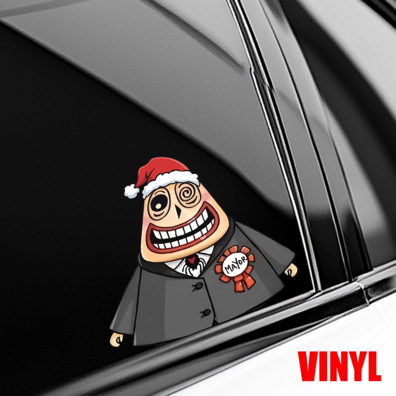 Op de afbeelding: Een kleurrijke vinyl sticker met een stripfiguur met een kerstmuts en een pak met een "Mayor" lint. Het personage heeft een brede grijns en spiraalogen. Het woord "VINYL" is in het rood gedrukt.