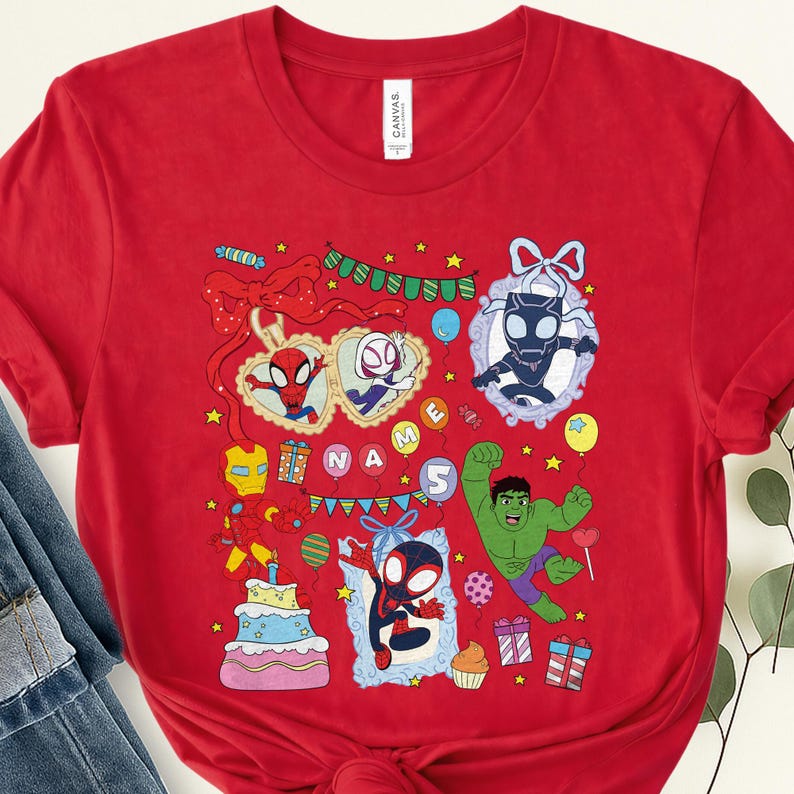 May include: A bright red short-sleeved t-shirt featuring a colorful graphic print of various superheroes, including Spider-Man, Iron Man, and Hulk, alongside birthday-themed elements like a cake, balloons, gift boxes, and the text NAME 5.