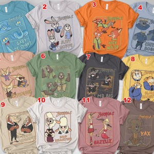 May include: A collection of twelve Zootopia 2 graphic t-shirts in various colors. Each shirt features a different character or group of characters from the animated movie, with text labels such as "Gary De Snake", "Judy Hopps", and "Nick Wilde".