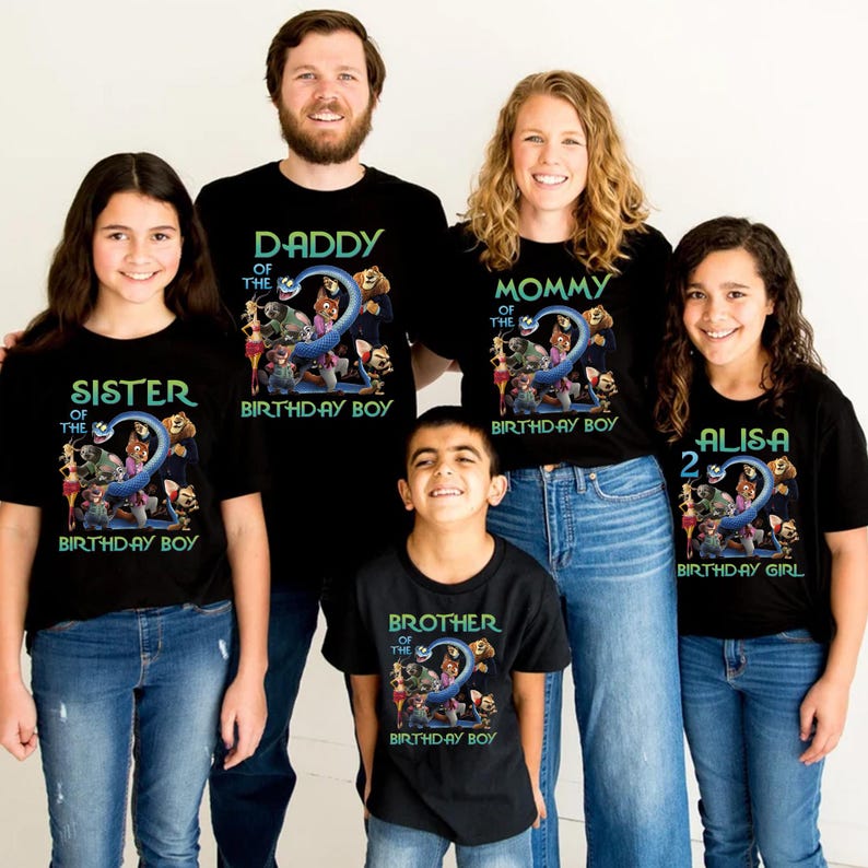May include: A family wearing matching black t-shirts with a birthday theme. The shirts have text that says "Daddy", "Mommy", "Sister", "Brother", and "Alisa" with "Birthday Boy" or "Birthday Girl" below. Each shirt features a colorful graphic with the number "2".