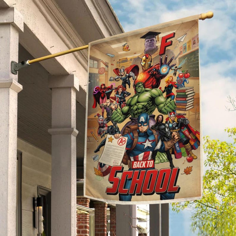 May include: A rectangular flag featuring a colorful illustration of various Marvel superheroes with the text "Back to School" in red. The flag is hanging from a gold-colored pole attached to a white structure.