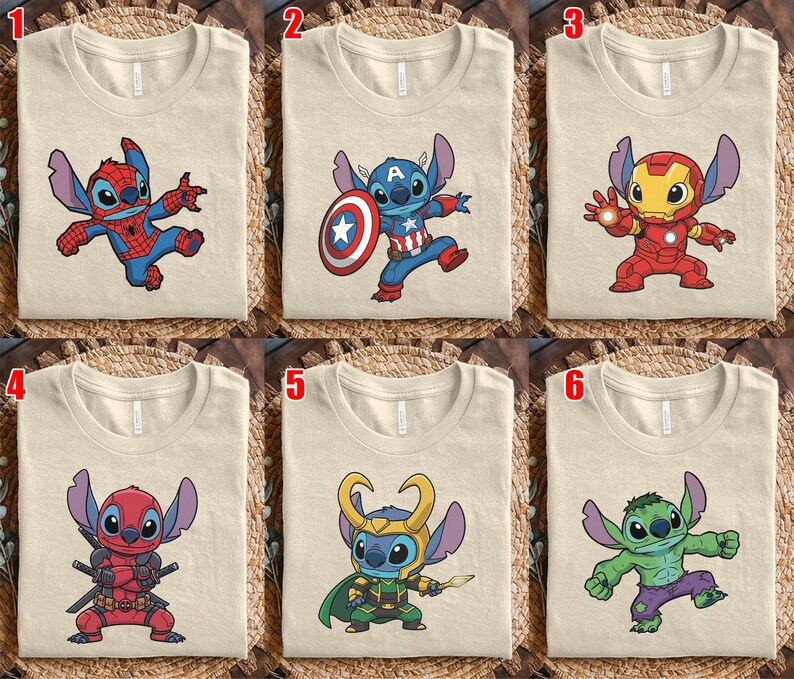 May include: Six beige t-shirts with cartoon character designs. The designs include Stitch dressed as Spider-Man, Captain America, Iron Man, Deadpool, Loki, and the Hulk. The shirts are folded and displayed on a woven surface.