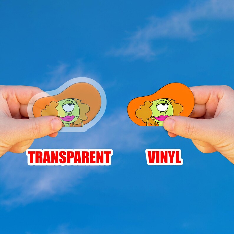 May include: Two stickers, one transparent and one vinyl, featuring a cartoon character with an orange hat and green skin. The word "TRANSPARENT" is printed in red on the left, and "VINYL" is printed on the right.
