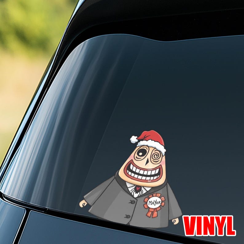 Op de afbeelding: Een vinyl sticker met een stripfiguur met een kerstmuts en een pak met een "Burgemeester" lint. Het personage heeft een brede grijns en spiraalogen. Het woord "VINYL" is rood.