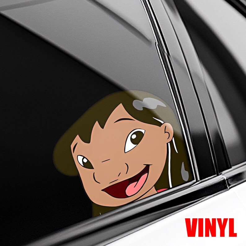 May include: A vinyl decal featuring a cartoon girl's face, smiling with a red mouth and brown hair. The decal is visible through a car window. The word "VINYL" is printed in red at the bottom.