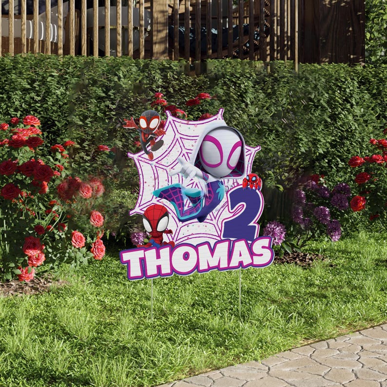 A Spider-Man themed birthday sign for a child named Thomas, featuring Spider-Man and Spider-Man logos, with the number "2" displayed.