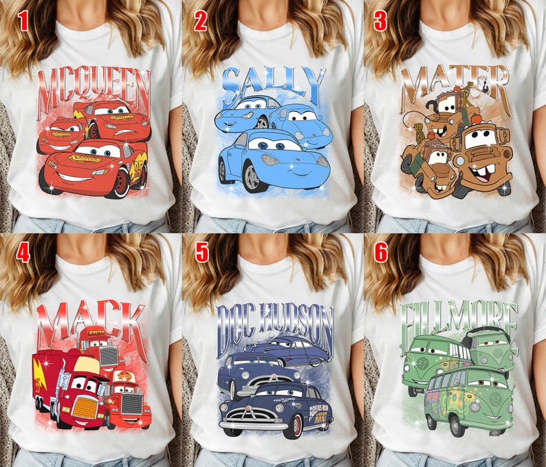 May include: White t-shirts with colorful graphics of characters from the animated movie Cars. The designs include Lightning McQueen, Sally, Mater, Mack, Doc Hudson, and Fillmore. Each shirt features a different character or group of characters.