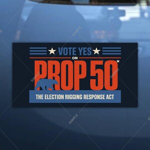 May include: A rectangular sticker with a dark blue background. The sticker features the text "VOTE YES" with stars and horizontal lines. Below, large orange text reads "PROP 50" with a blue bear silhouette. The text "THE ELECTION RIGGING RESPONSE ACT" is at the bottom.