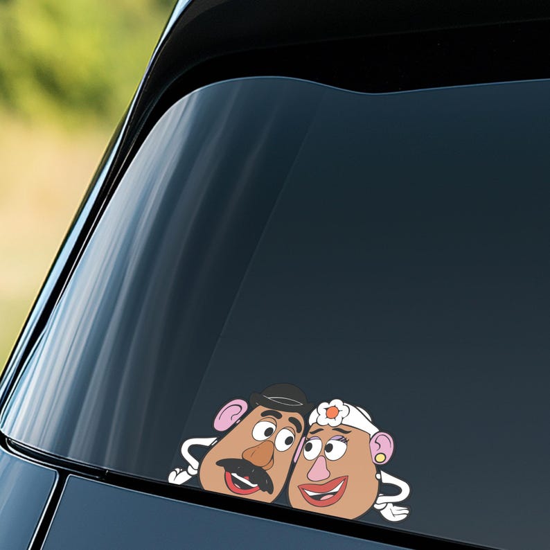 May include: A car window decal featuring a cartoon couple, Mr. and Mrs. Potato Head. The male character has a black hat and mustache, while the female character wears a white headband with a flower. Both have smiling red lips.
