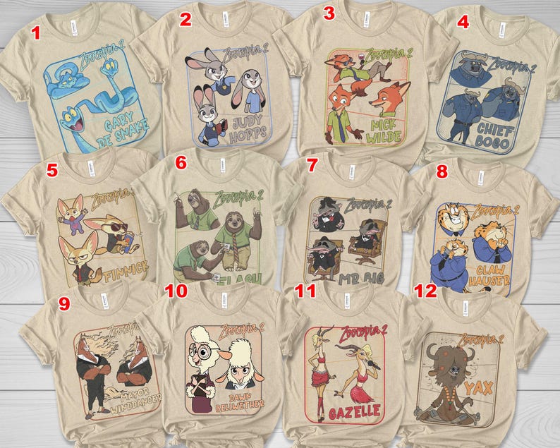May include: A collection of beige t-shirts featuring various characters from the animated film "Zootopia 2". Each shirt displays a different character or group of characters with their names, such as "Judy Hopps" and "Nick Wilde".