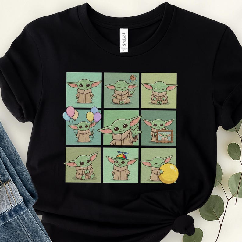 May include: Black t-shirt with a grid of nine cartoon images of a green alien character. Each image shows the character in different poses, with props like balloons and a ball. The shirt has a classic crew neck.