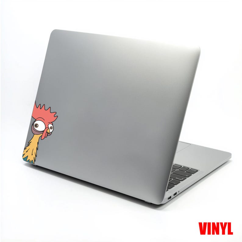 May include: A gray laptop with a cartoon chicken sticker peeking from the side. The chicken has a red comb, yellow neck, and large, expressive eyes. The word "VINYL" is printed in red at the bottom right.