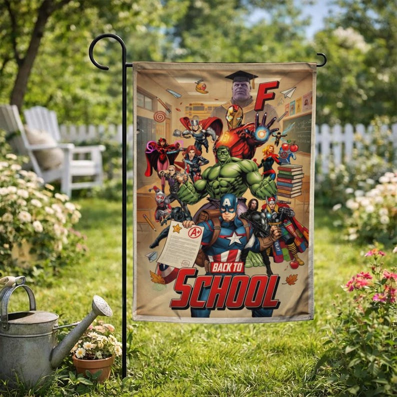 May include: A garden flag featuring a comic book-style illustration of various superheroes, including Captain America and the Hulk, with the text "Back to School". The background depicts a classroom setting.