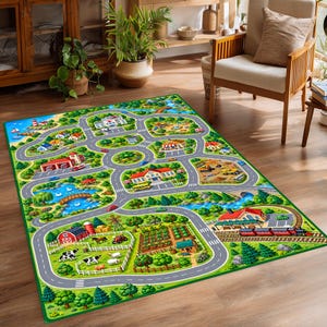 May include: A rectangular area rug featuring a colorful illustrated town map with roads, buildings, a farm with animals, a train track, a construction site, and a pond. The design includes green landscapes, blue water, and various vehicles on the roads.
