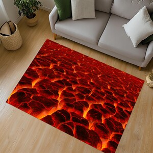 May include: A rectangular rug depicting a 3D rendering of molten lava. The rug's design features a fiery colour scheme of red, orange, and black, creating a textured appearance. The rug is placed on a light-coloured wooden floor.