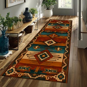 May include: A long rectangular runner rug featuring a geometric pattern with repeating diamond shapes and horizontal bands in shades of teal, burnt orange, cream, and dark brown, finished with a decorative border along the edges.
