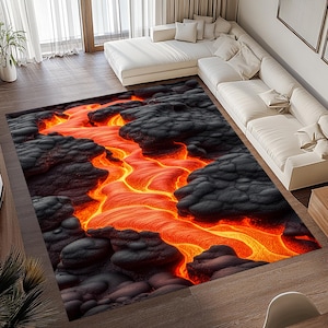 May include: A rug with a realistic image of a river of lava flowing through a field of black volcanic rock. The rug has a bright orange and yellow color scheme.