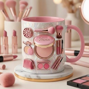 May include: A white ceramic mug with a pink interior and handle, decorated with makeup items. The mug features a pearlescent finish and is adorned with blush, brushes, lipsticks, and the word "Name". The mug sits on a marble coaster.