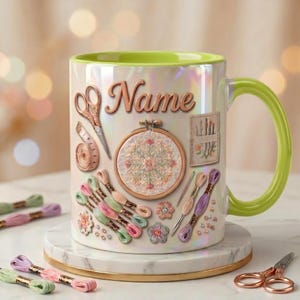 May include: A white iridescent ceramic mug with a lime green interior and handle, featuring a printed design of embroidery supplies including scissors, a measuring tape, an embroidery hoop, needles, and colorful thread skeins with the word Name.