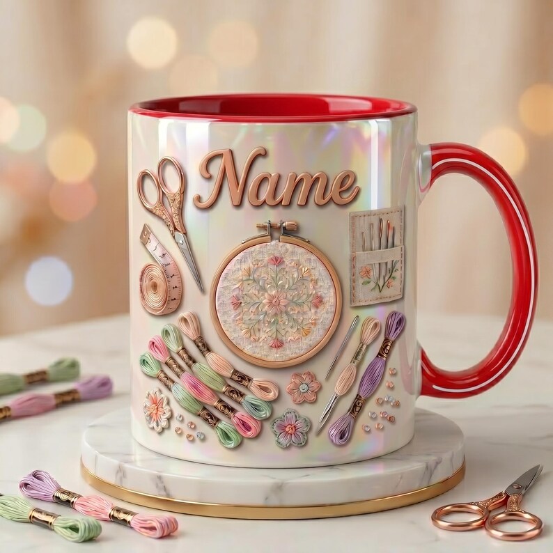 May include: A white iridescent ceramic mug with a red interior and handle, featuring a printed design of embroidery supplies including scissors, a measuring tape, an embroidery hoop, needles, and colorful thread skeins with the text Name.