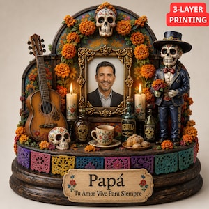 May include: A Day of the Dead memorial display featuring a central portrait of a man, a guitar, a skeleton figure in a suit, marigold flowers, candles, a cup, and skull accents. The base has a plaque reading Papá Tu Amor Vive Para Siempre.