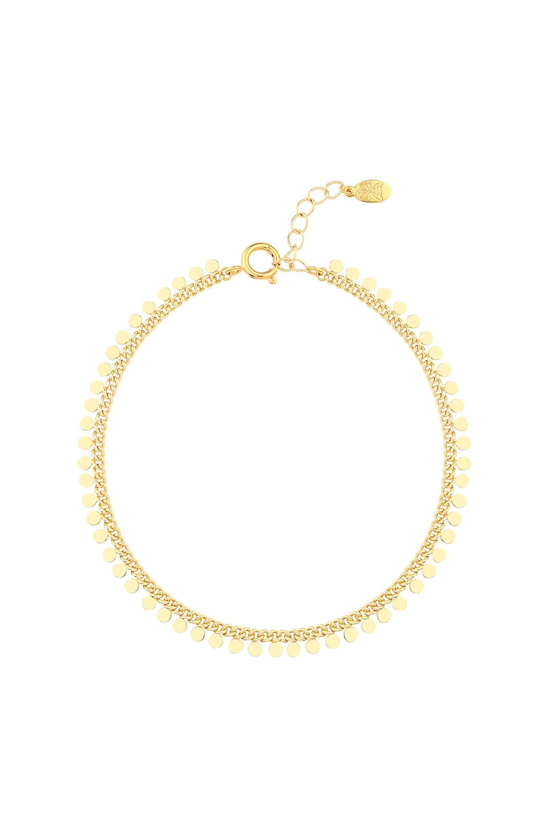 May include: A gold chain bracelet with small, round charms hanging from it.