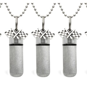 May include: Five silver cremation urns with a checkered flag design. Each urn is attached to a silver chain.