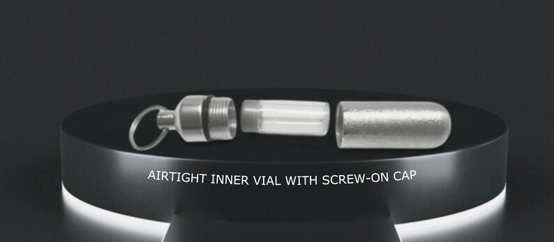 May include: A silver, airtight vial with a screw-on cap. The vial is separated into three parts: a cap, a clear glass tube, and a base with a ring for attaching a keychain.