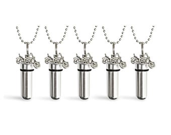May include: Five silver-toned motorcycle pendant necklaces. Each necklace features a small motorcycle charm above a cylindrical vial. The vials are attached to a silver chain.