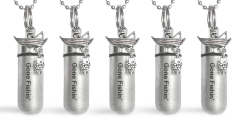 May include: Five silver-toned pendants with a boat and fish charm. Each pendant has the text "Gone Fishin'" engraved on it.