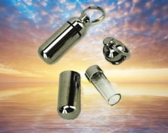 May include: Four silver metal containers with a key ring attached to one. The containers are cylindrical and have a screw-on lid. The containers are perfect for storing small items like pills, jewelry, or ashes.