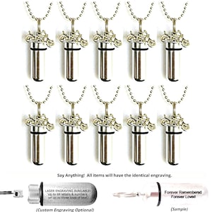 May include: Silver-colored motorcycle urn necklaces displayed in a group. Each necklace features a cylindrical pendant with a motorcycle charm and a ball chain. The image includes text about engraving options.