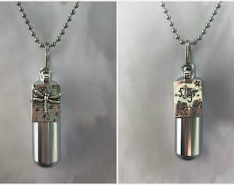 May include: A silver-colored pendant necklace with a cylindrical base and a rectangular top. The top features a dragonfly design and star accents. The word "fly" is etched on the top of the pendant in some images. The necklace has a ball chain.