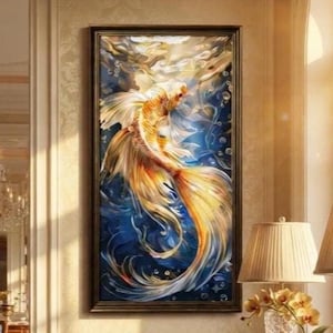 May include: A rectangular framed wall art piece featuring a vibrant golden koi fish swimming through deep blue water with swirling currents and bubbles. The fish has long, flowing fins and scales rendered in shades of yellow, orange, and white.